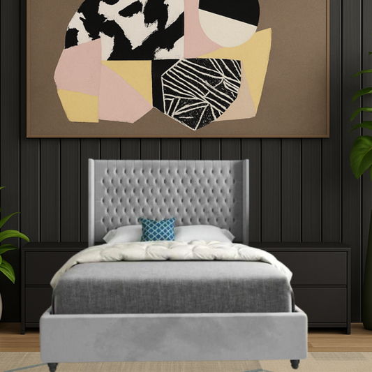 Gray upholstered single bed frame with button-tufted headboard in modern bedroom, abstract art, dark nightstands, plants.