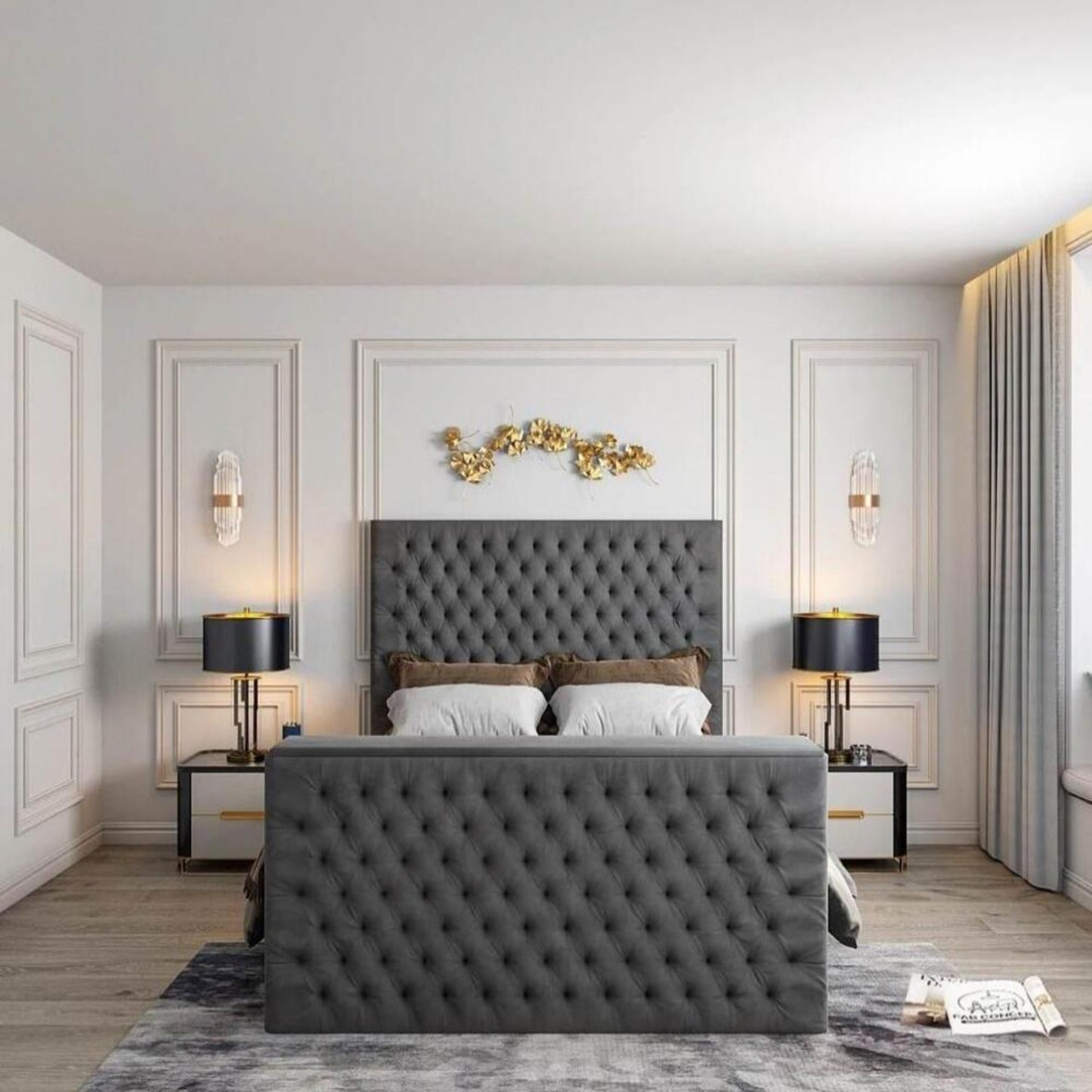 Bedroom with grey tufted 2025 Florence TV bed, white pillows, gold accents, black lamps, and elegant wall decor.