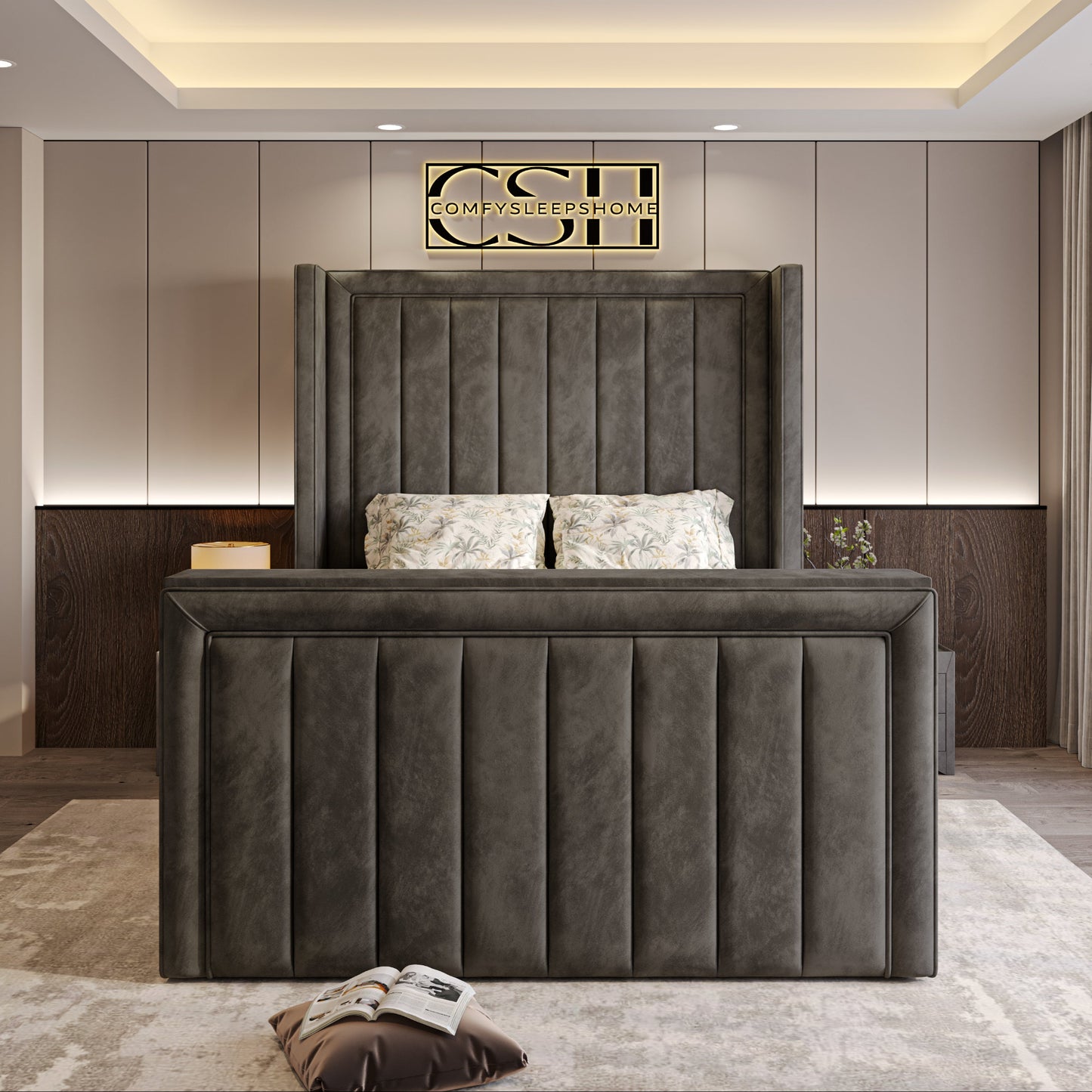 A dark gray tufted-panel bed in a modern room with floral pillows, artistic walls, and recessed lighting. 2025 The Astoria TV Bed.