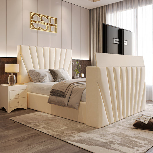 A luxurious cream 2025 The Chelsea TV Bed with a grand, channel-tufted headboard and a pop-up television, in a chic bedroom.