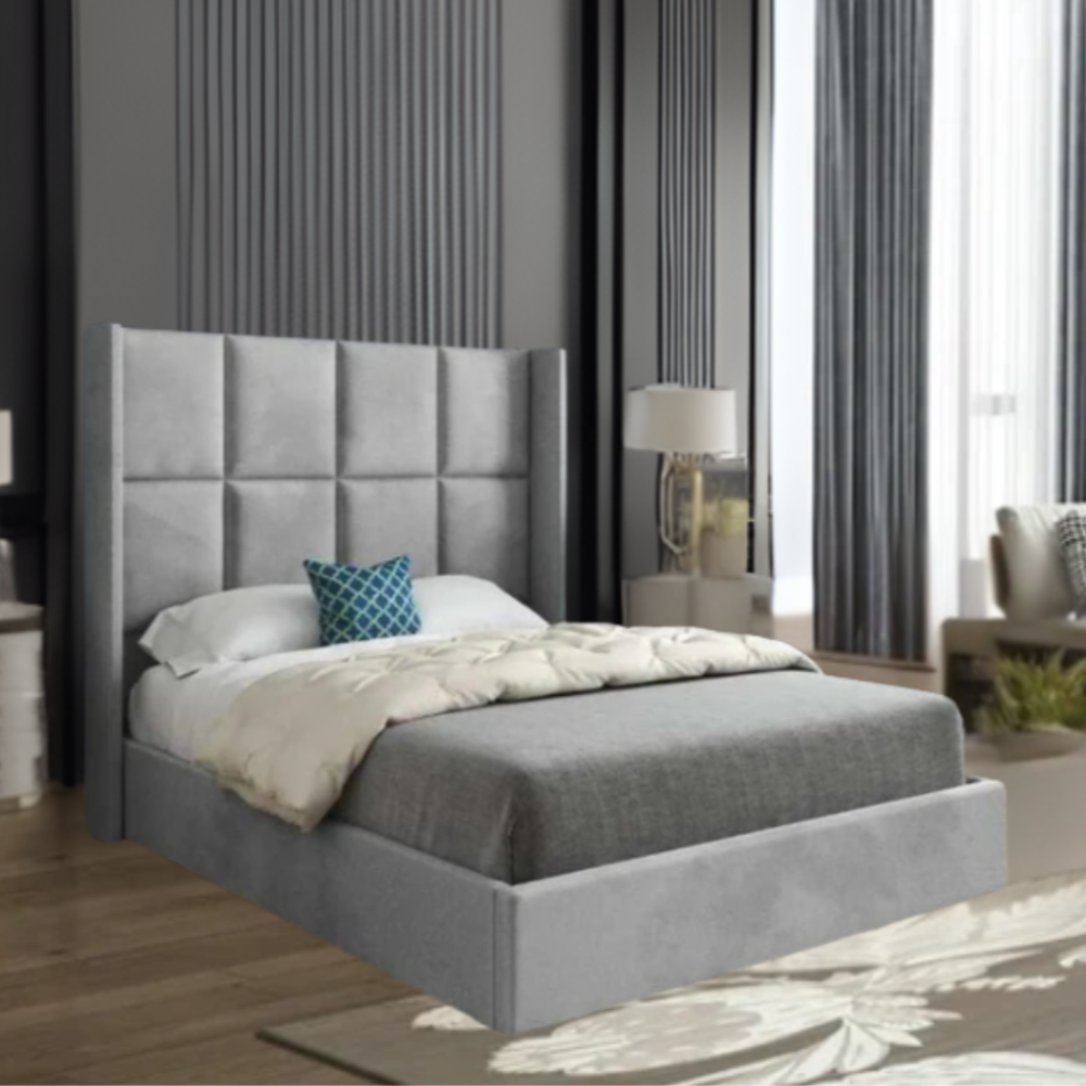 Modern bedroom with a gray upholstered bed and decorative blue pillow.