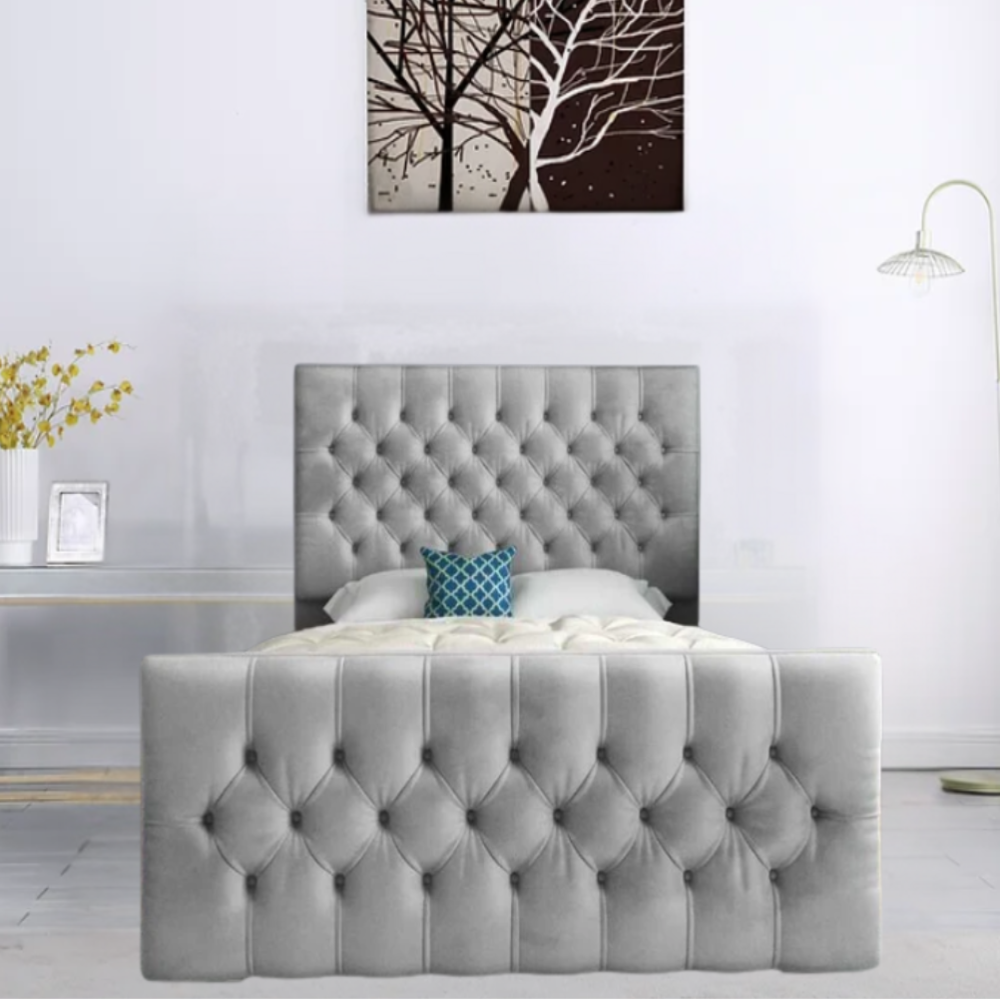 Gray tufted bed with teal pillow, against a minimalist interior setting.