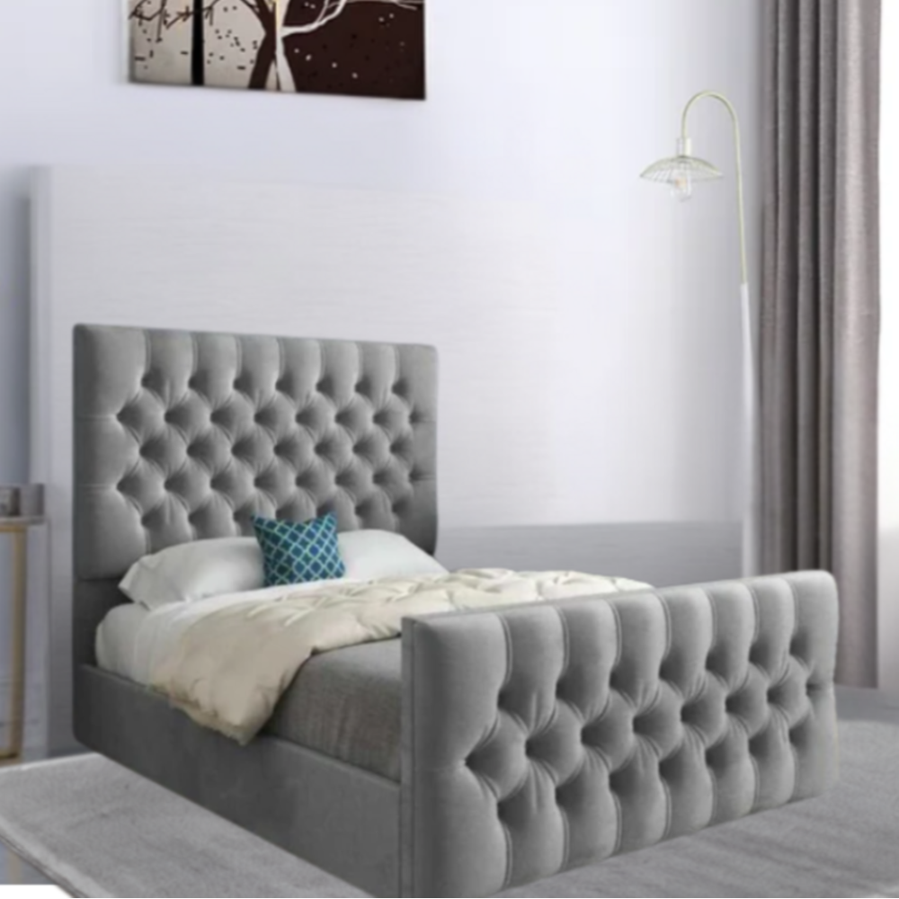 Bedroom with a grey tufted bed, blue pillow, white bedding, and a canvas art piece on the wall.