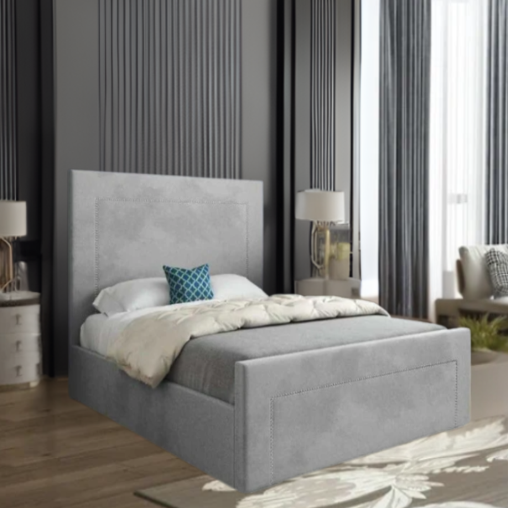 Modern bedroom with gray upholstered bed and teal accent pillow.