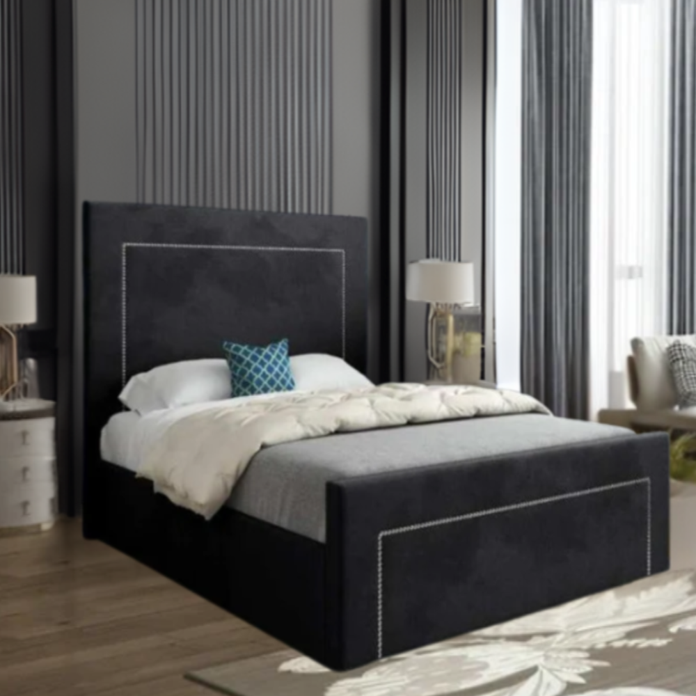 Modern bedroom with a black upholstered bed and blue decorative pillow.