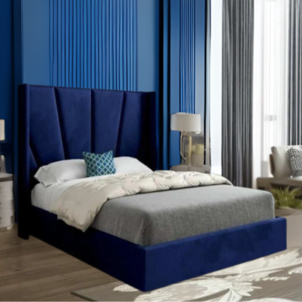 Modern bedroom with a blue upholstered bed and decorative elements.