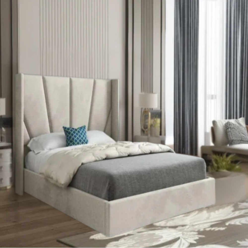 Modern bedroom with a bed with tall cushioned headboard, gray bedding, and blue pillow.