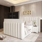 Modern bedroom with a bed, upholstered headboard, nightstand, and recessed lighting.