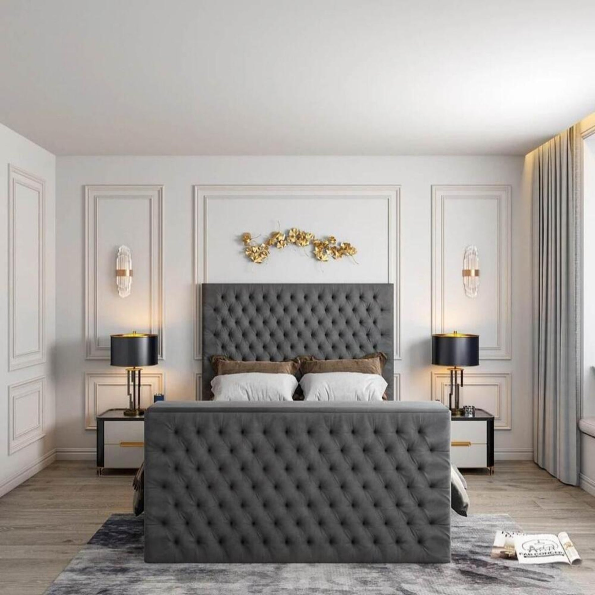 Bedroom with grey tufted 2025 Florence TV bed, white pillows, gold accents, black lamps, and elegant wall decor.