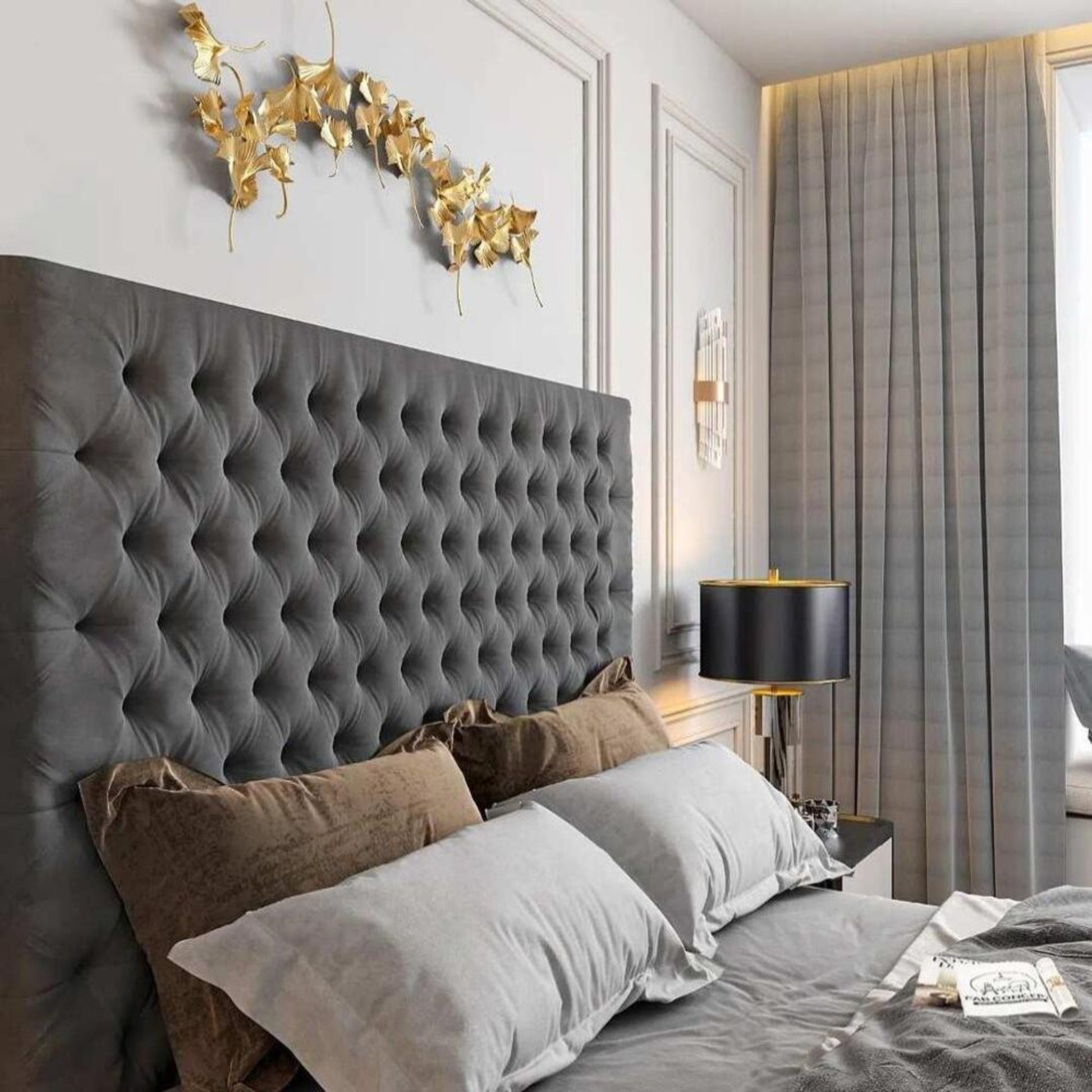 Modern bedroom with tall tufted headboard, pillows, a decorative lamp, and golden wall art. Features a 2025 Florence TV bed.
