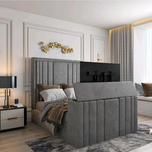 A bedroom with a 2025 lily TV bed, showcasing a gray upholstered headboard and footboard with a concealed TV, elegant décor.