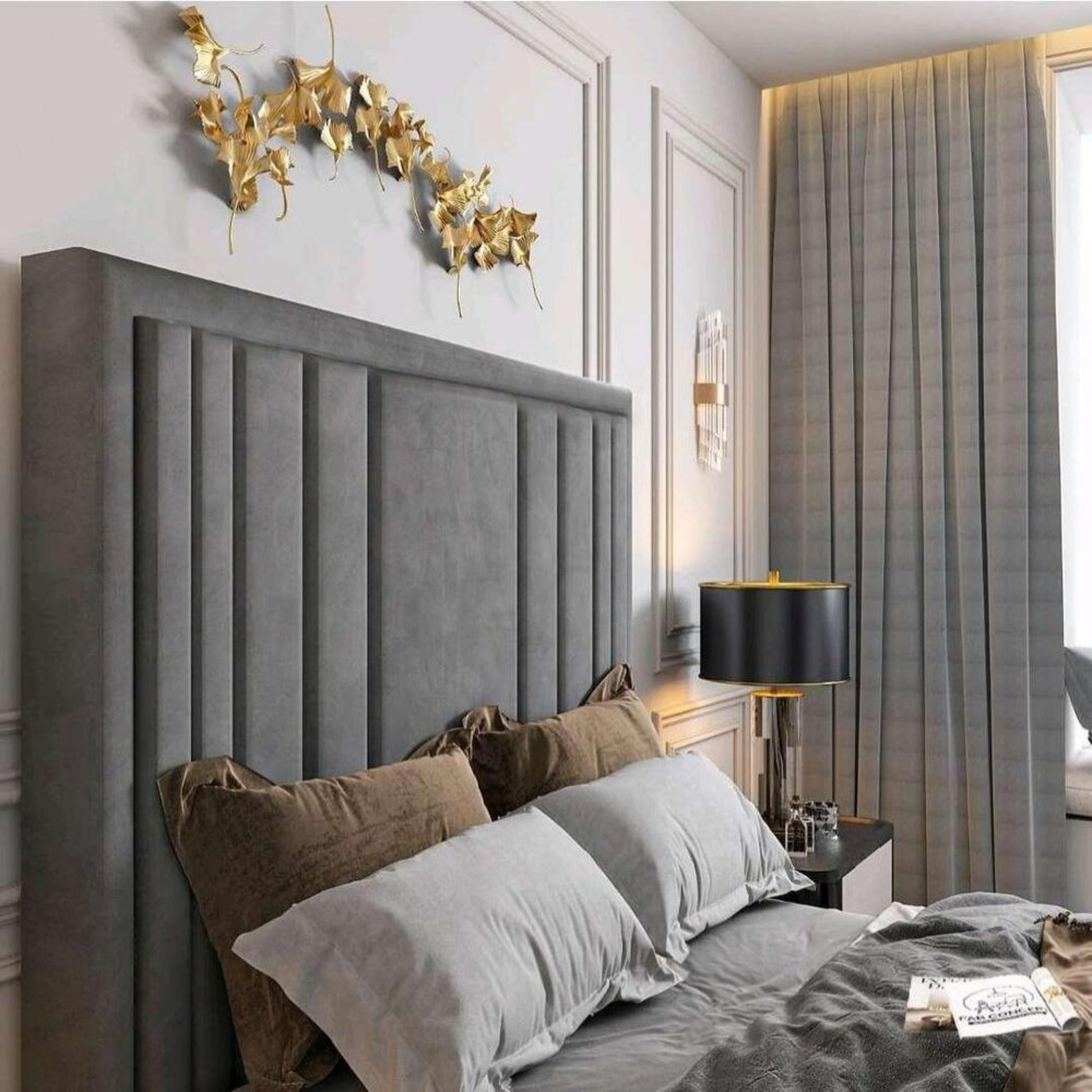 Elegant bedroom with plush grey headboard, decorative golden leaves, and sleek furnishings. 2025 lily tv bed setting.