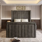 A dark gray tufted-panel bed in a modern room with floral pillows, artistic walls, and recessed lighting. 2025 The Astoria TV Bed.
