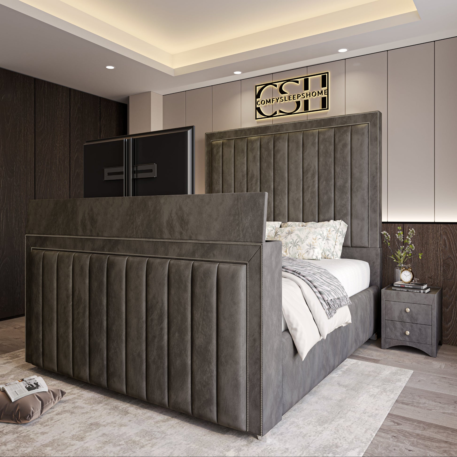 Modern bedroom with the 2025 The Zenith TV Bed featuring a gray tufted headboard, chandelier, and integrated footboard TV.