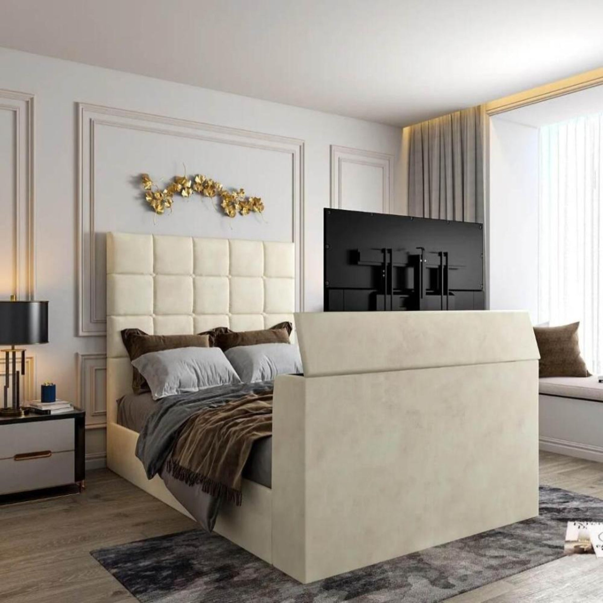 Modern bedroom with cream 2025 Windsor TV bed, tall tufted headboard, TV at foot, gold decor, wood floors, and large window.