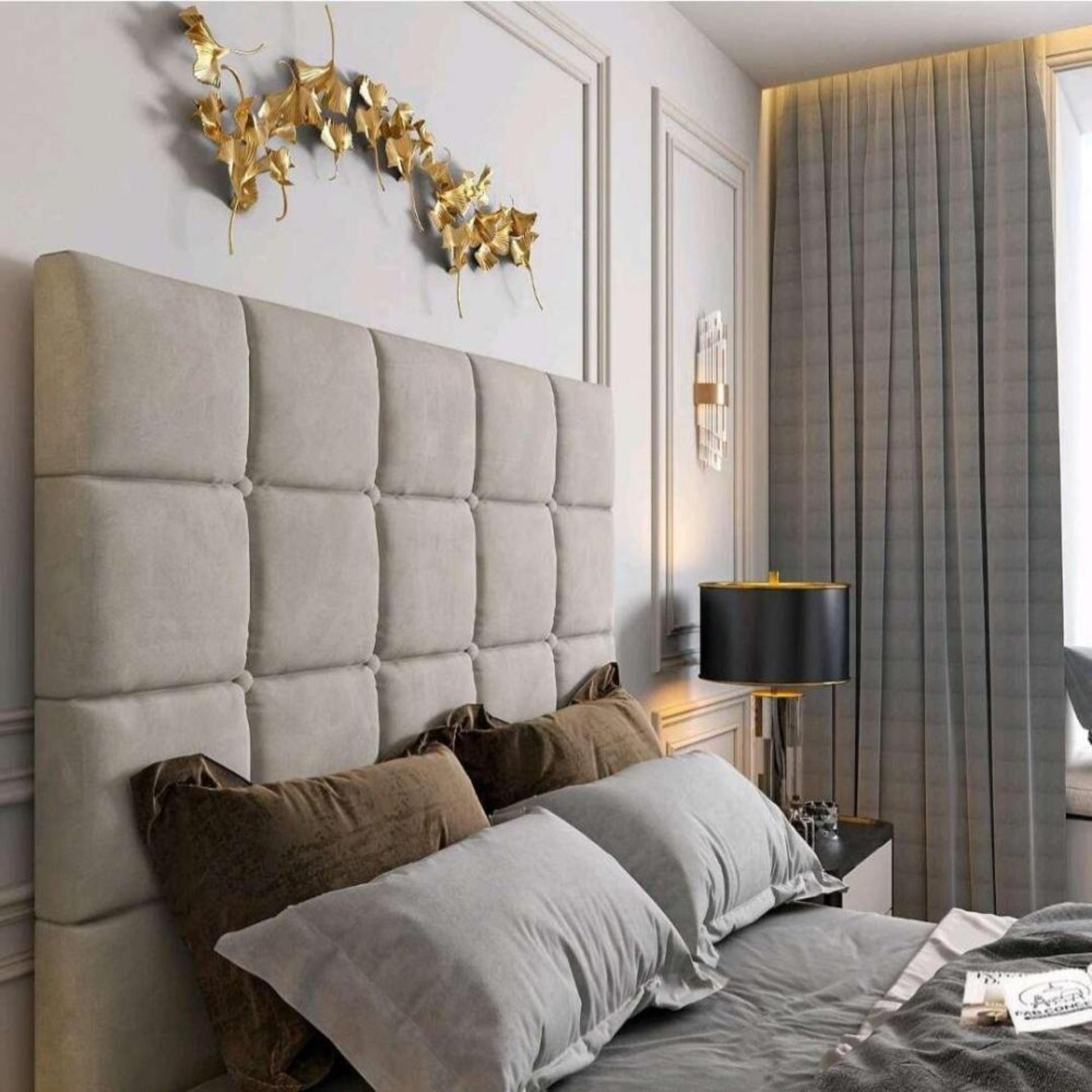 Bedroom with tufted gray headboard, pillows, decorative golden wall art, and a lamp; part of the 2025 Windsor TV Bed setup.