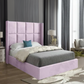 Modern bedroom with a tall light purple upholstered bed, decorative pillows, and elegant decor.