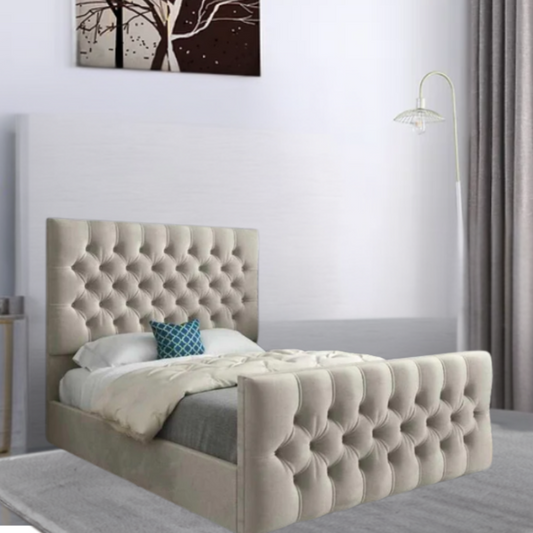 A beige tufted bed with decorative pillows and a modern floor lamp in a bedroom with abstract tree artwork on the wall.