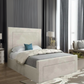 Modern bedroom with upholstered bed, beige headboard, and blue accent pillow.