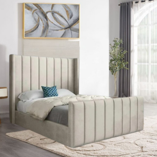 A modern bedroom with a light gray tufted bed, abstract wall art, and tall windows with gray curtains.