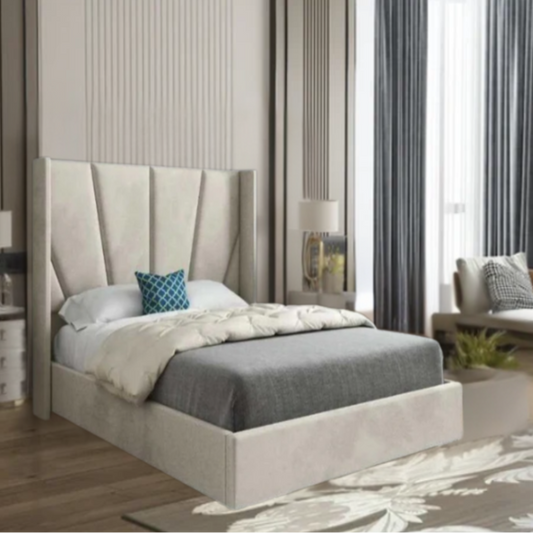 Modern bedroom with a bed with tall cushioned headboard, gray bedding, and blue pillow.