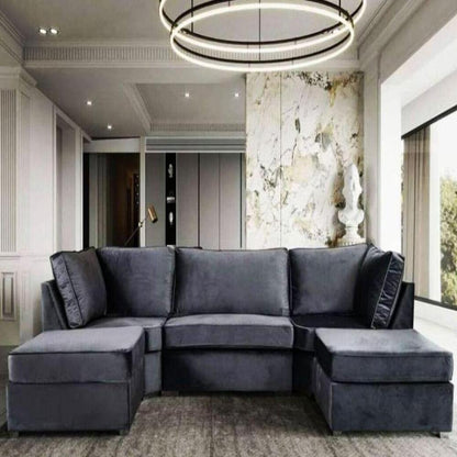 Modern living room with a dark gray sectional U Shape Elveden Sofa sofa, circular light fixture, marbled wall, and large window.