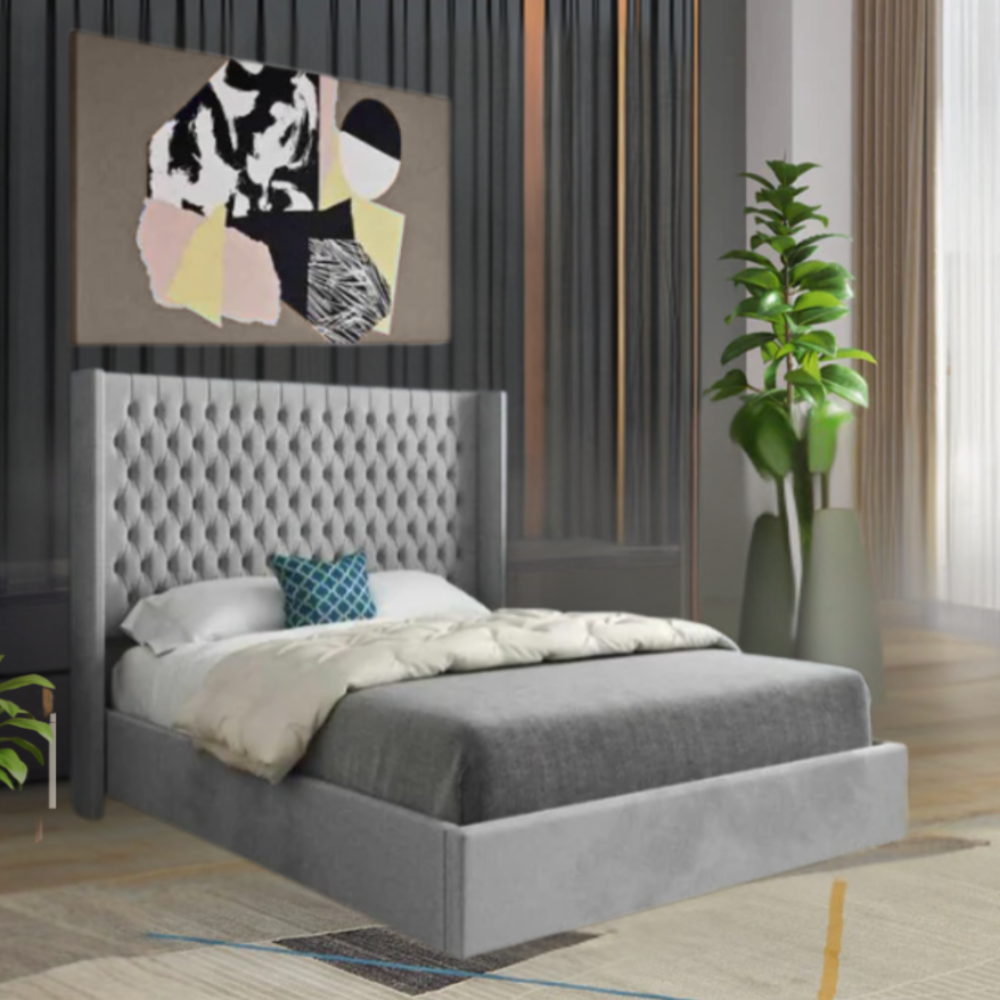 Modern bedroom with a grey tufted bed, abstract artwork, and a tall green plant.